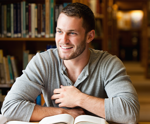 Caucasian man seated in the library